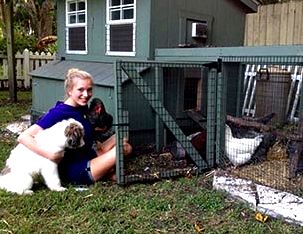 Customer with Chicken and Puppy in Front of Chicken Coop